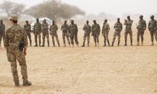 A U.S. Army Special Forces weapons sergeant speaks to a group of Nigerien soldiers before a training exercise.