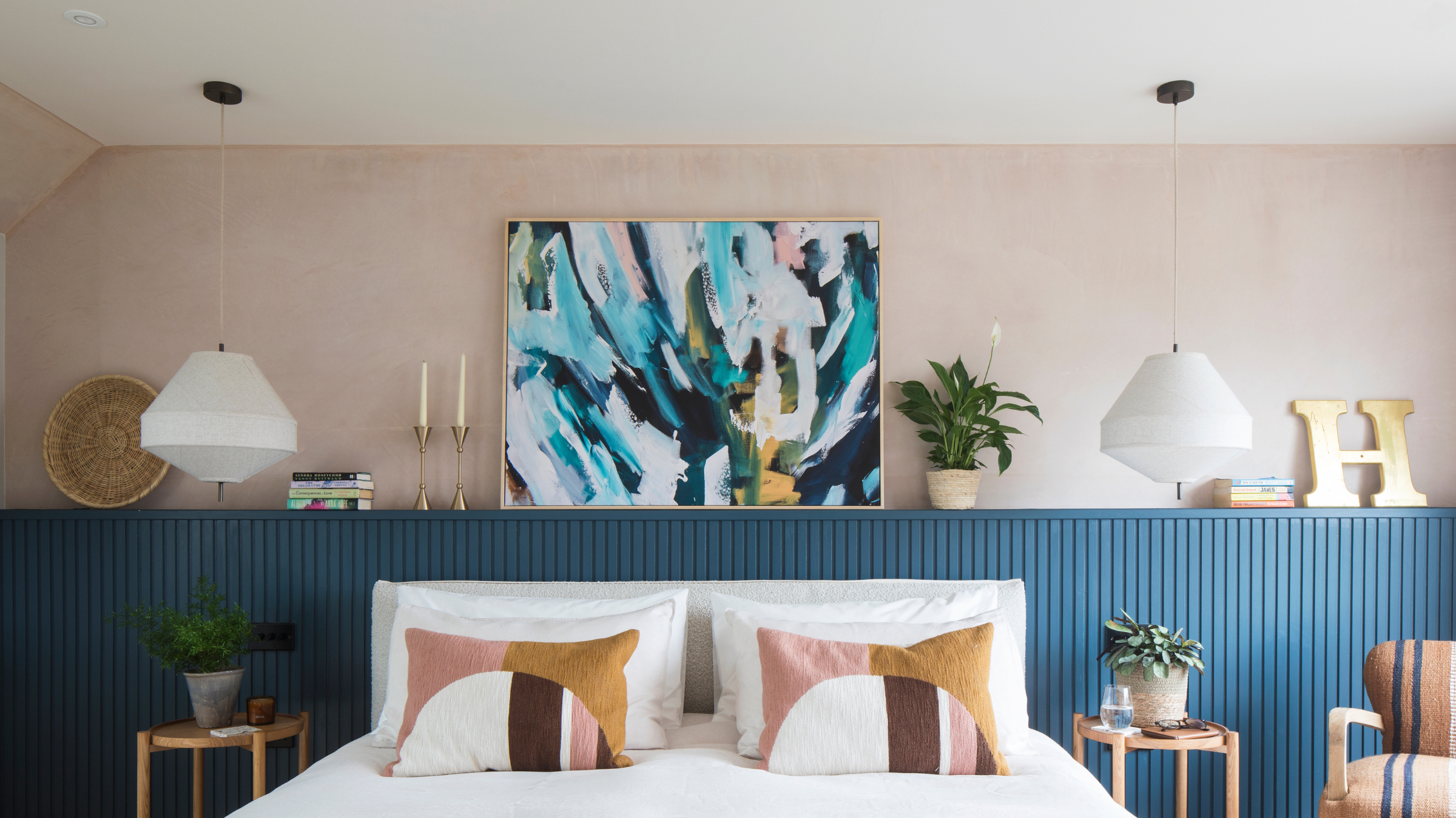 Pink bedroom with white ceiling and blue panelling.