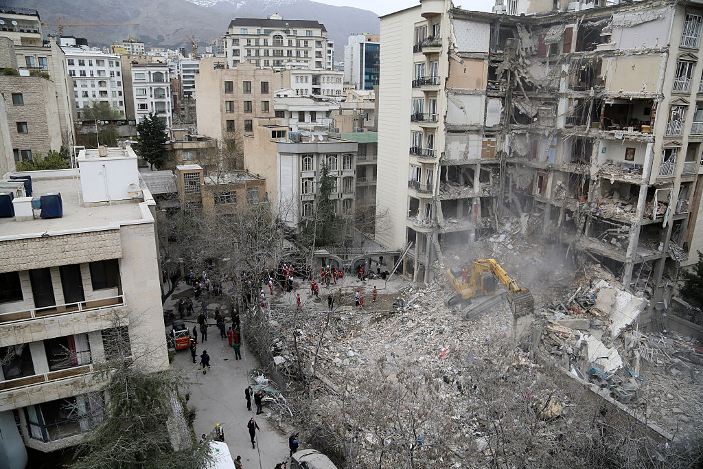 Aerial view of a destroyed building in Iran's capital of Tehran. A digger is clearing the rubble.