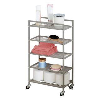 A metal rolling cart with toilet rolls, brushes, towels and products