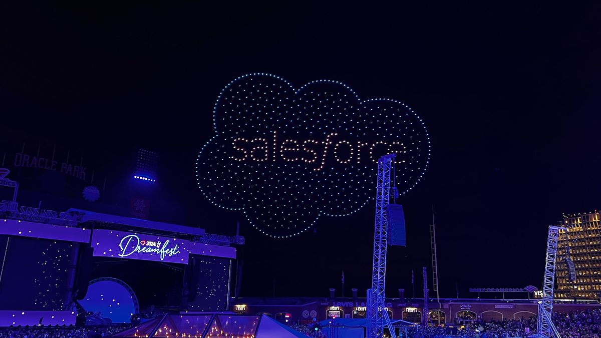 Salesforce logo illuminated in sky above Oracle Park during drone show at Dreamforce 2024 Dreamfest concert.