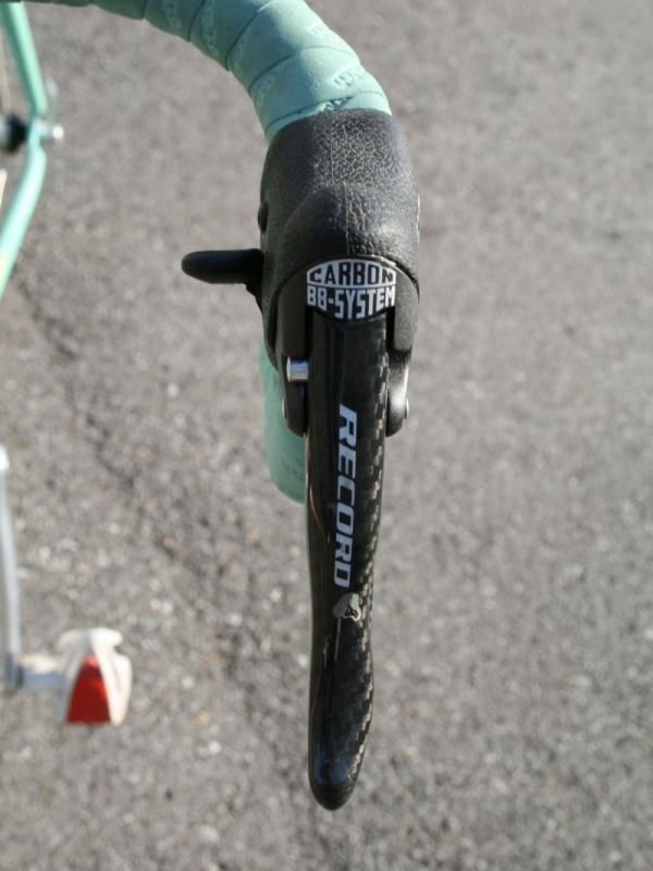 Nine-speed Campagnolo Record Ergopower levers are mounted low on the bars.