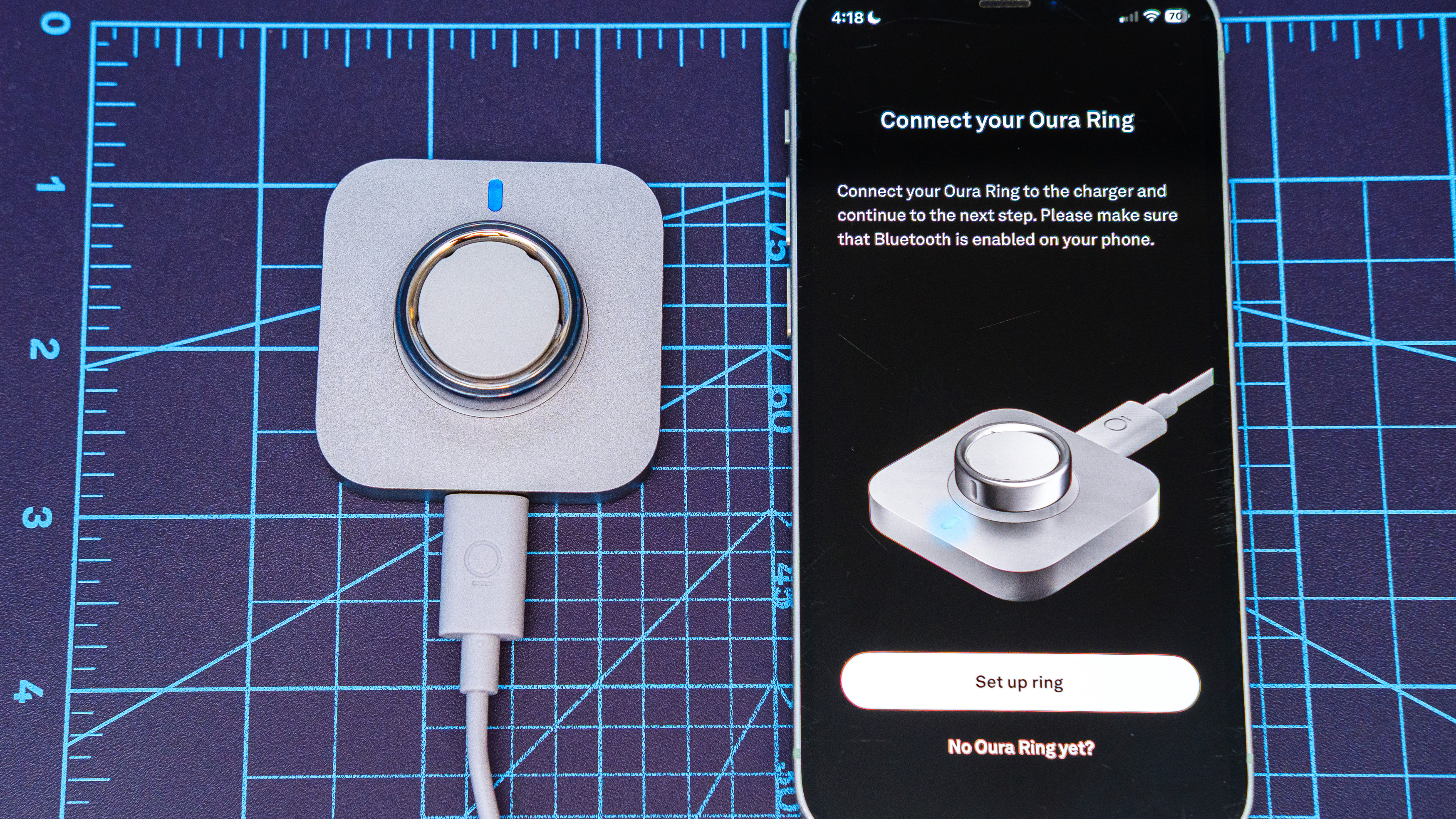 Oura Ring 4 Ceramic close-up showing the setup and pairing process using an iPhone