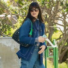 Dakota Johnson wears a studded bag.