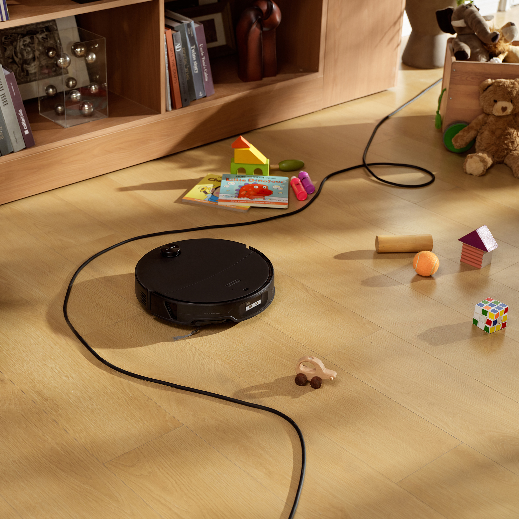 Robot vacuum cleaner navigating around toys and cords