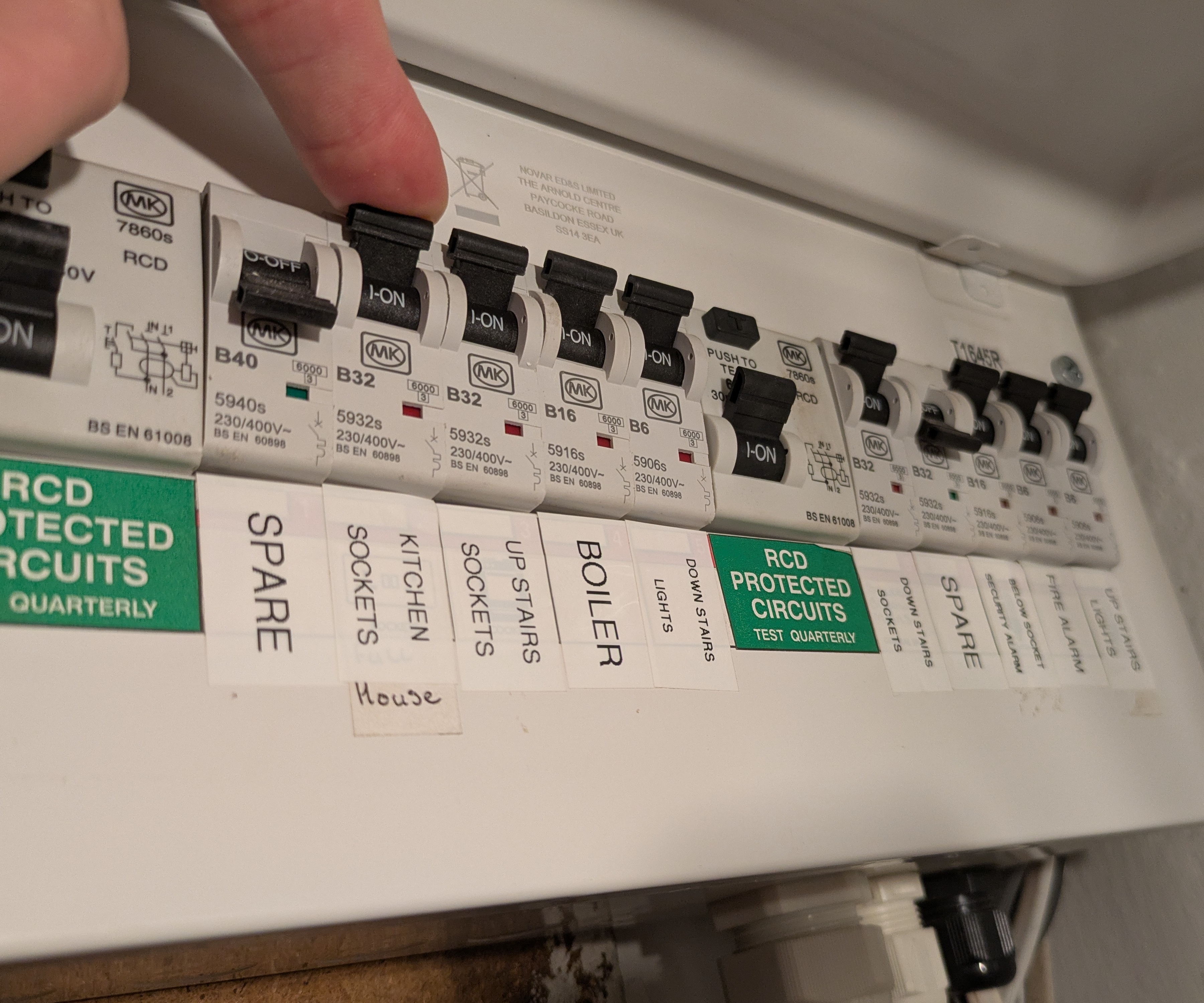 Flipping a circuit breaker switch on a consumer unit