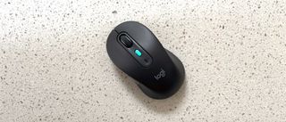 The Logitech Signature AI Edition M750 mouse on a worktop.