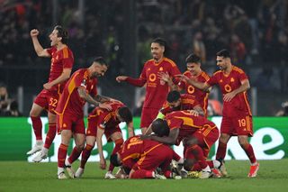 Roma players celebrate a goal against AC Milan in the Europa League in April 2024.