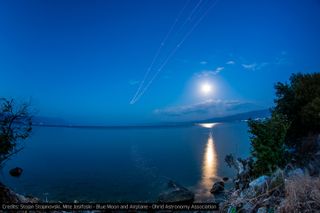 The Blue Moon full moon of July 2015 and the lights of an airplane are seen in the night sky near Ohrid, Macedonia in this photo captured by astrophotographer Stojan Stojanovski of the Ohrid Astronomy Association.