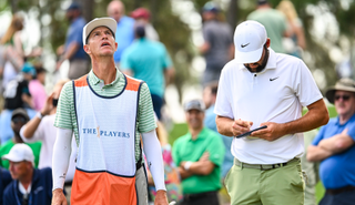 Ted Scott and Scottie Scheffler chat during The Players Championship