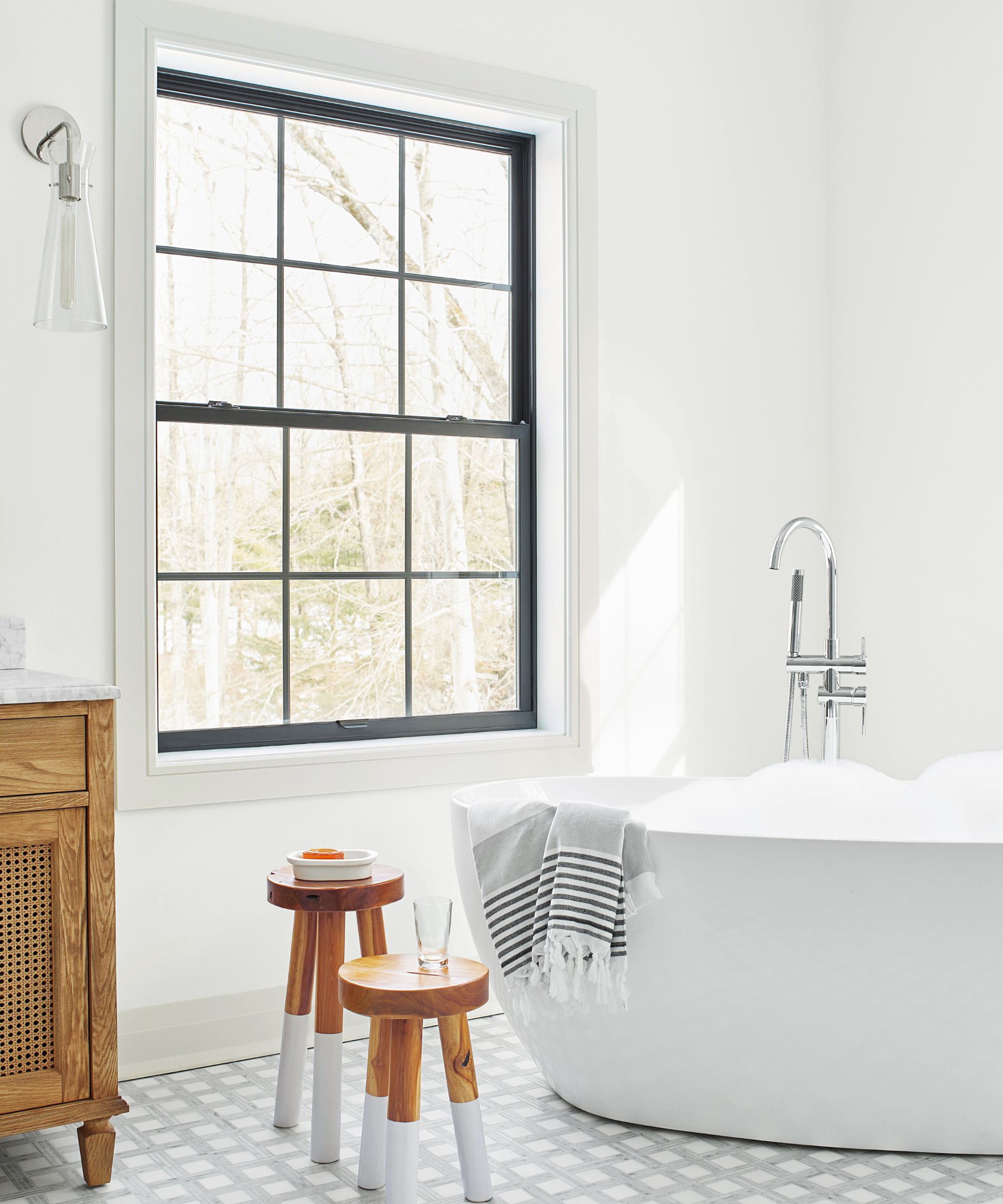 A white bathroom with wooden furniture