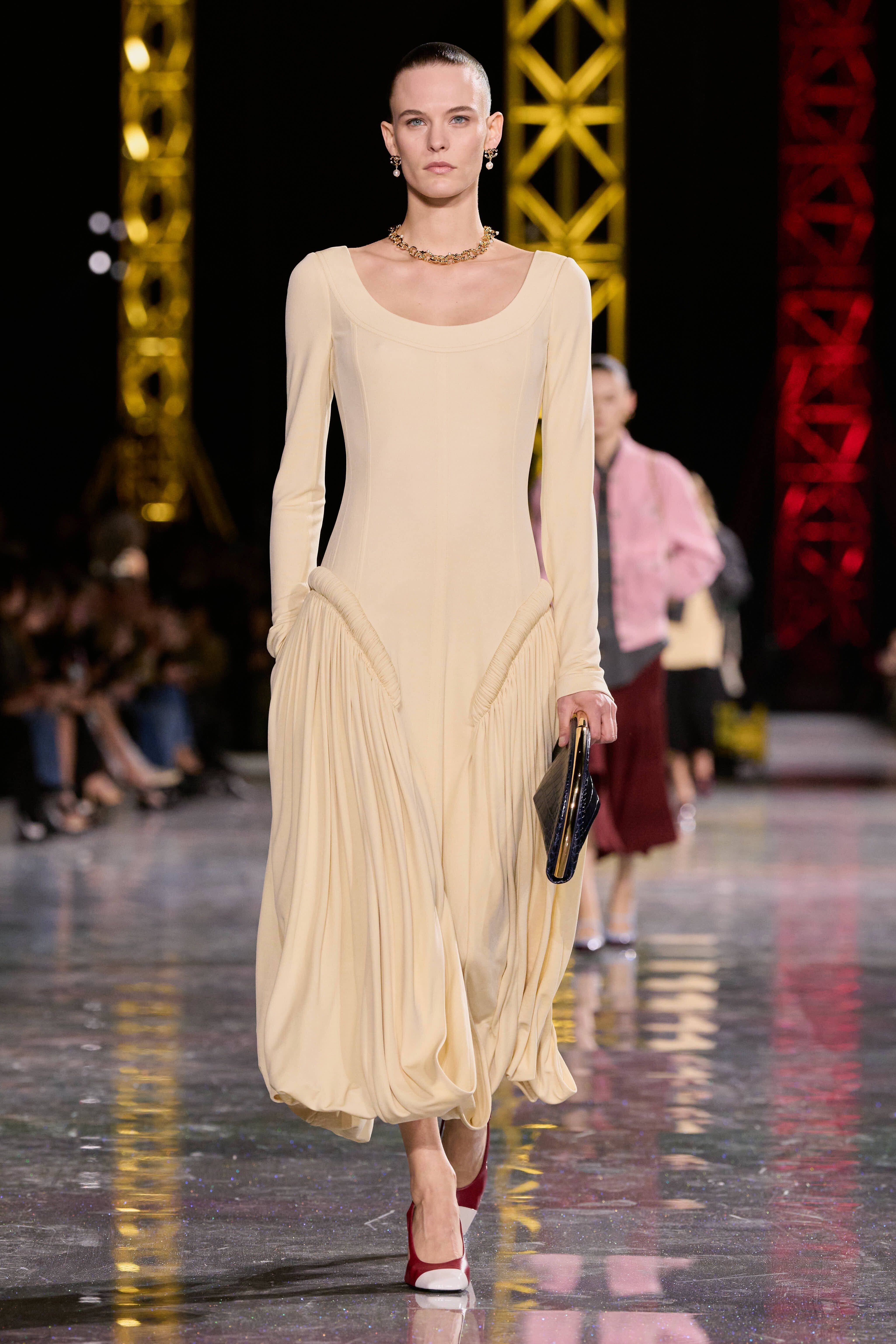 a model on the runway at chanel aw26 wearing a butter yellow dress