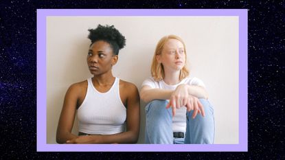 sad female couple sitting next to each other and looking in opposite directions on a dark, starry background