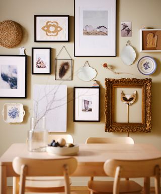 gallery wall with prints and plates and mirrors in a dining room