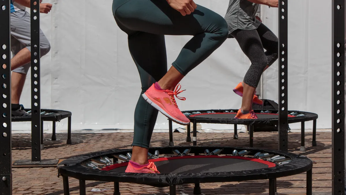 three people doing a workout on a rebounder