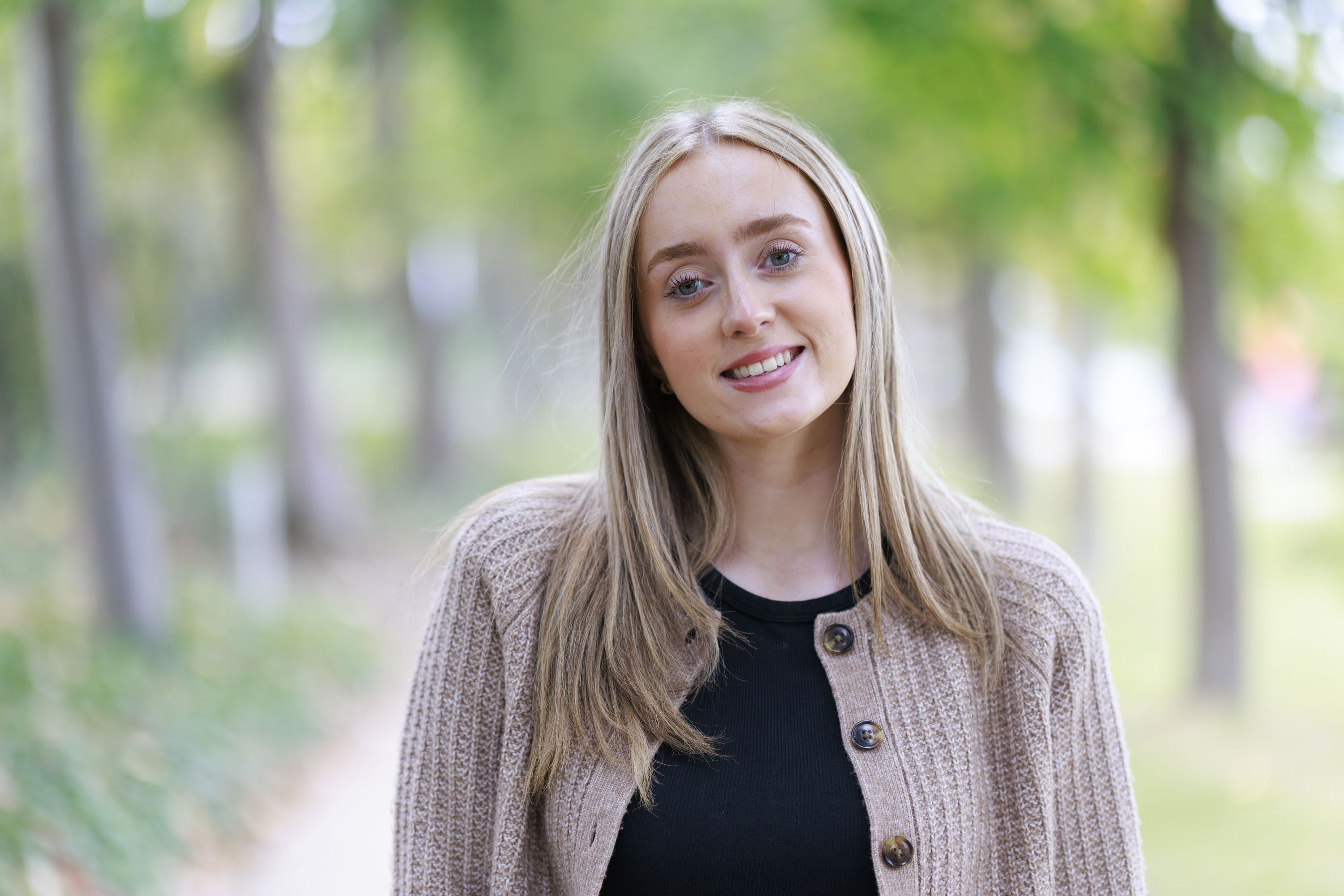 Portrait of a woman framed within an avenue of trees, taken with the Canon RF 85mm F1.4L VCM lens