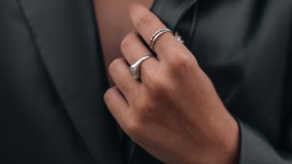 Female Hands In A Black Stylish Leather Jacket And Silver Accessories On A Female Body. - stock photo