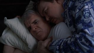 Steve Martin and John Candy look confused while cuddling in Planes, Trains, and Automobiles.