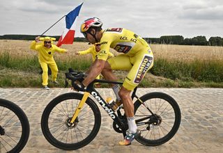 JumboVisma teams Belgian rider Wout Van Aert wearing the overall leaders yellow jersey cycles across a cobblestone sector during the 5th stage of the 109th edition of the Tour de France cycling race 1537 km between Lille and Arenberg Porte du Hainaut in northern France on July 6 2022 Photo by Marco BERTORELLO AFP Photo by MARCO BERTORELLOAFP via Getty Images