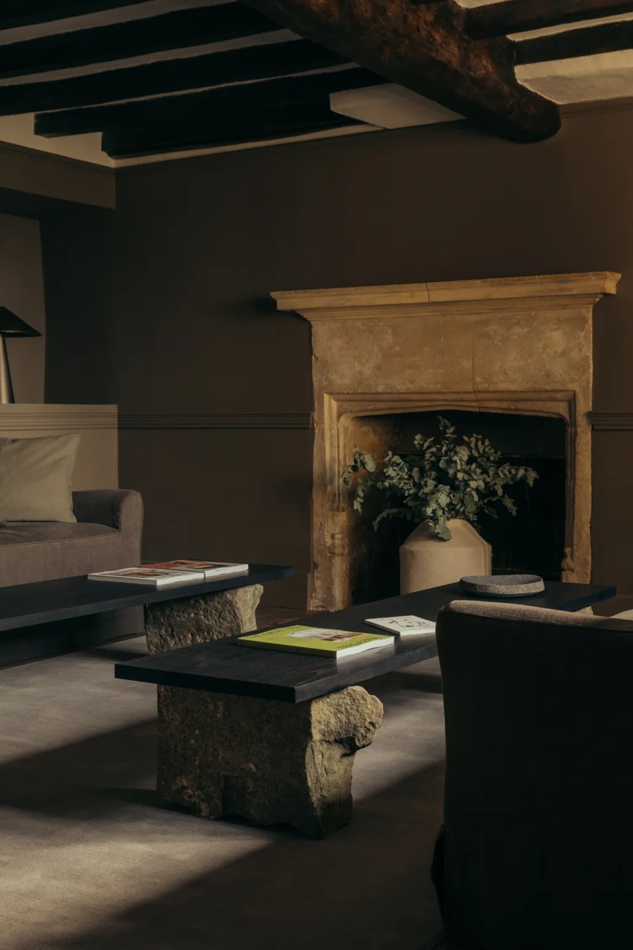 a cottage living room with a rustic fireplace