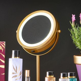 golden circular mirror with light