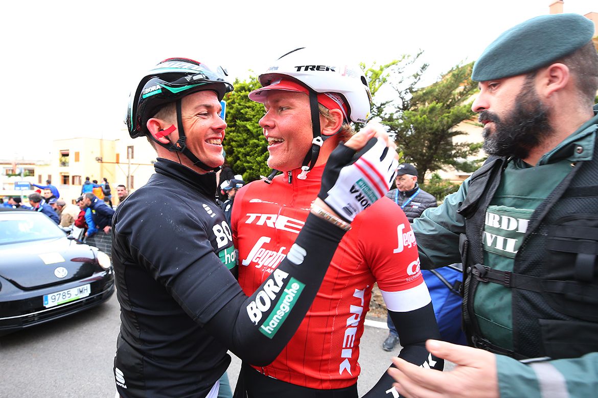 Toms Skujins (Trek-Segafredo) is congratulated by Gregor M&uuml;hlberger (Bora-Hansgrohe)
