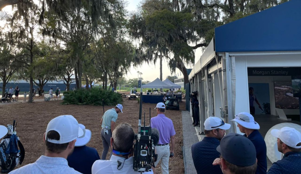 Sam Burns and his caddie talk over a shot at TPC Sawgrass