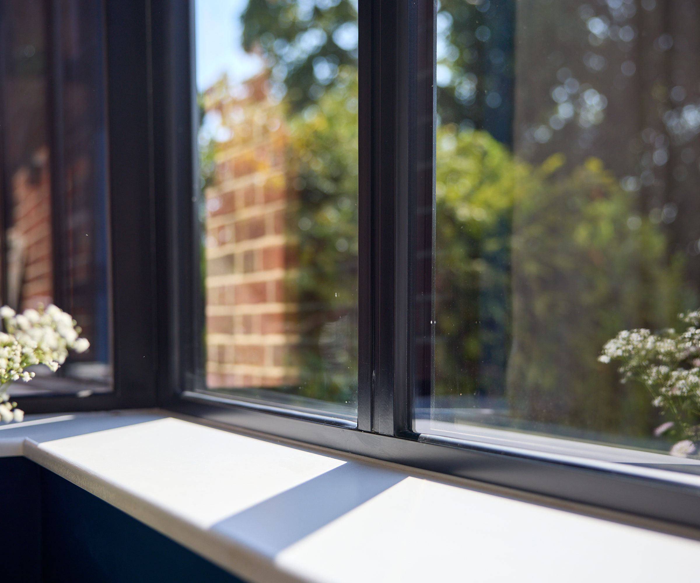 close up of a windowsill and an aluminium-framed window