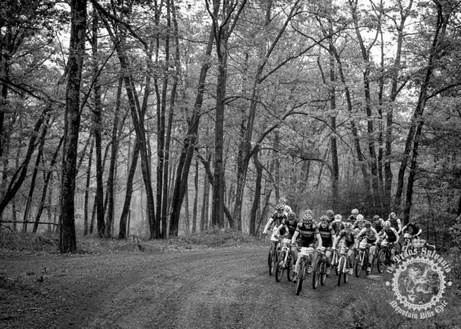 An early breakaway pushes hard through the mist to gain time on the peloton.