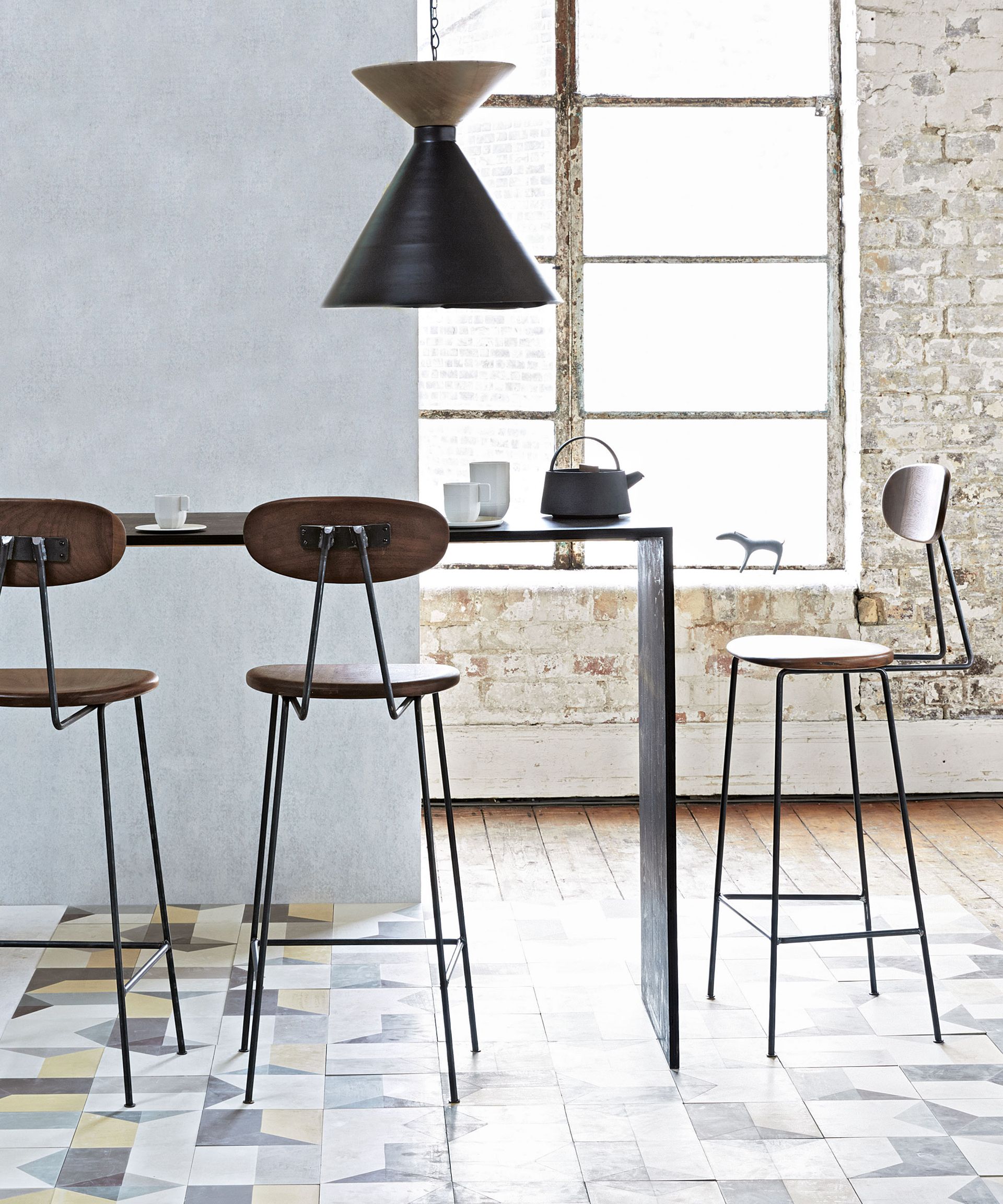 Small dining room with narrow table and bar stools