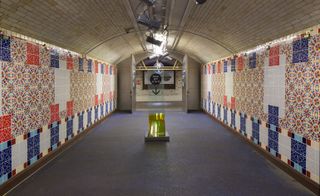 Arched tunnel lined with colourful patterned tiles