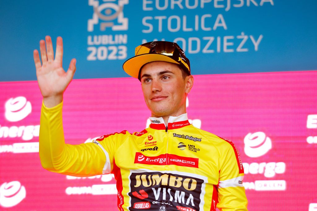 Olav Kooij (Jumbo-Visma) in the Tour de Pologne leader&#039;s jersey celebrates on the podium after stage 1