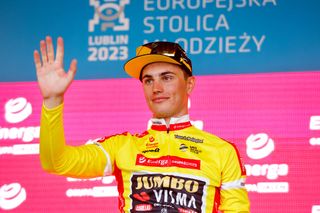 Olav Kooij (Jumbo-Visma) in the Tour de Pologne leader's jersey celebrates on the podium after stage 1