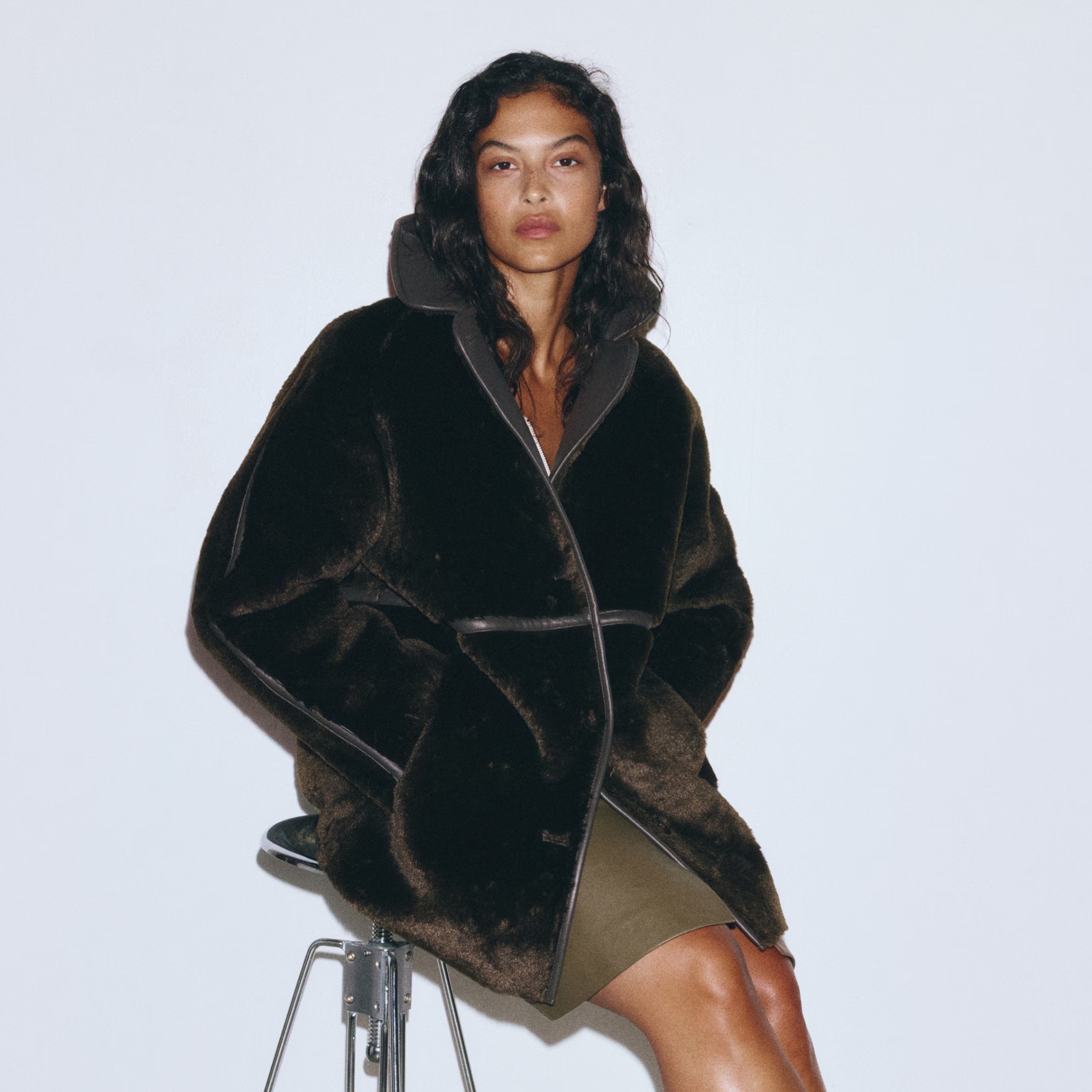 A model wears khaki fluffy jacket from H&M.