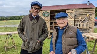 Jay Blades and David Jason standing outside a shed in David and Jay's Touring Toolshed