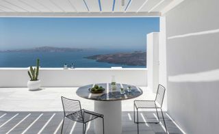 Table & chairs on balcony overlooking Mediterranean sea