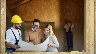 builder showing male and female plans in extension being built