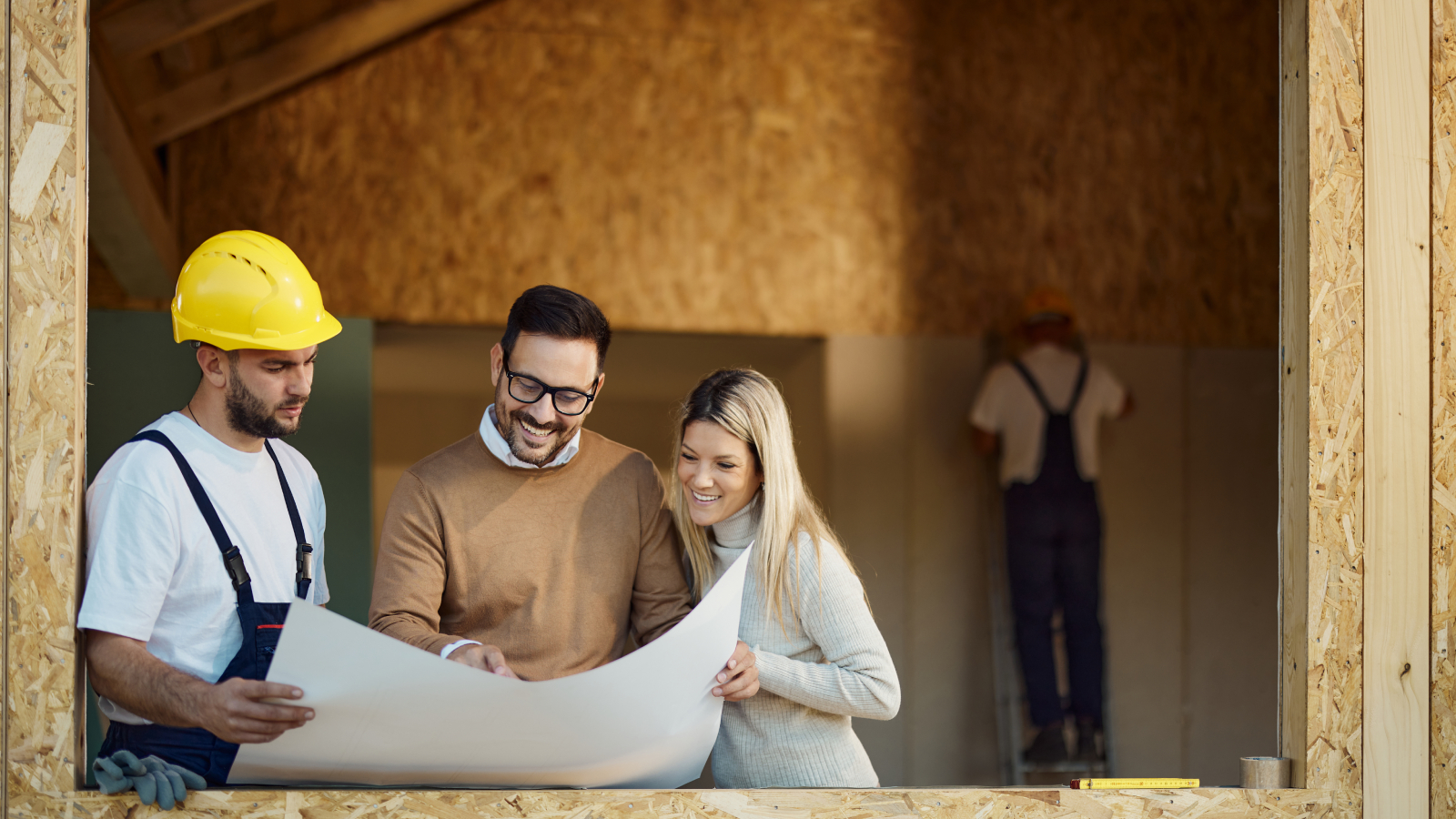builder showing male and female plans in extension being built