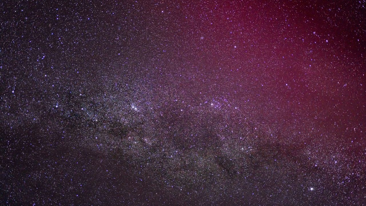 milky way at night with some pink aurora borealis