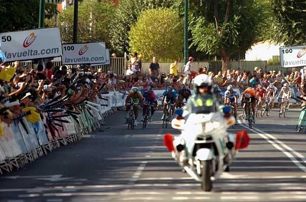 The riders round the final corner as the sprinters hit the gas.