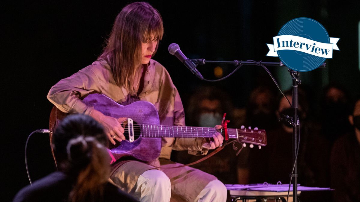 Feist onstage playing guitar in Toronto