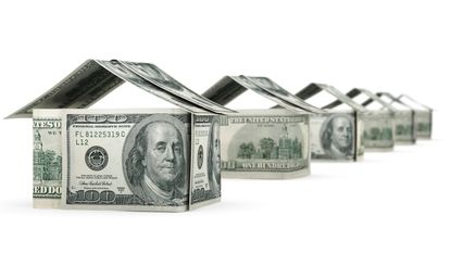 Hundred-dollar bills are folded to look like houses.