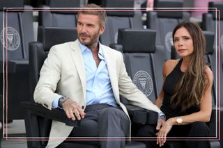David and Victoria Beckham holding hands in the stands at a football match