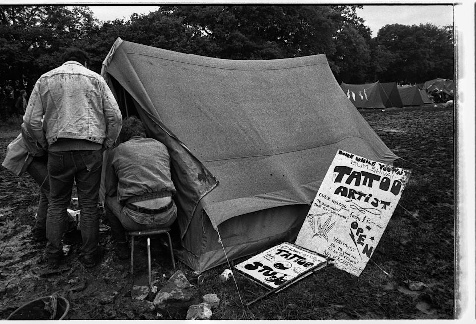 Makeshift tattoo tent at Glastonbury in the 1980s