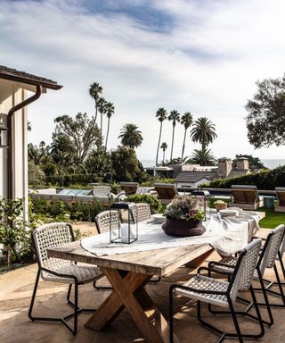 Outdoor dining table with view of palm trees and sea