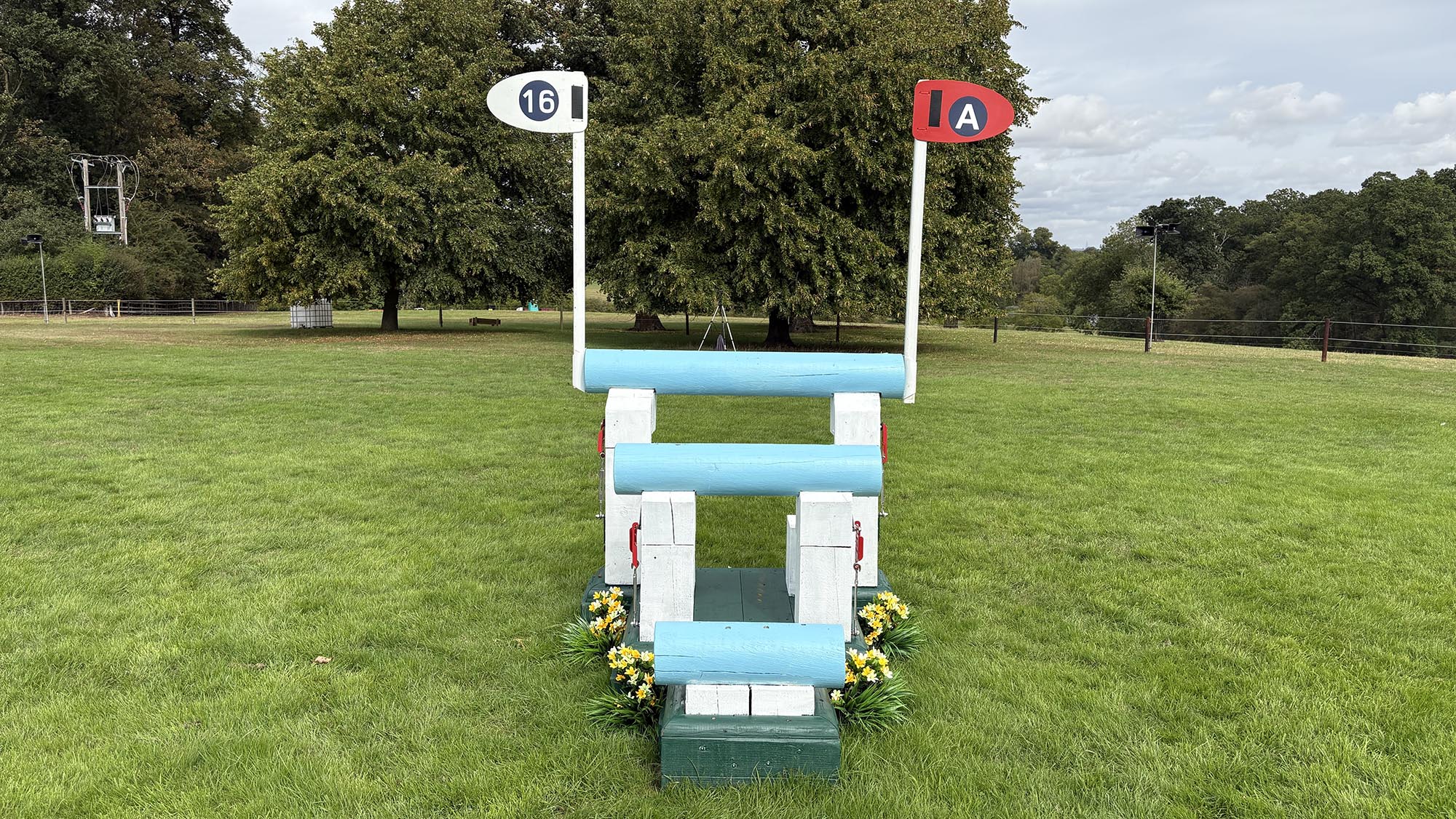Blue triple brush arrowhead fence on the Burghley cross-country course 2026