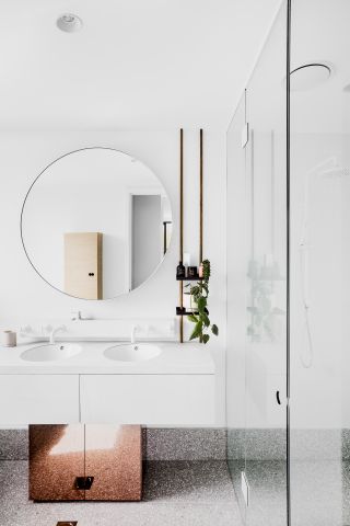 white bathroom with oval mirror