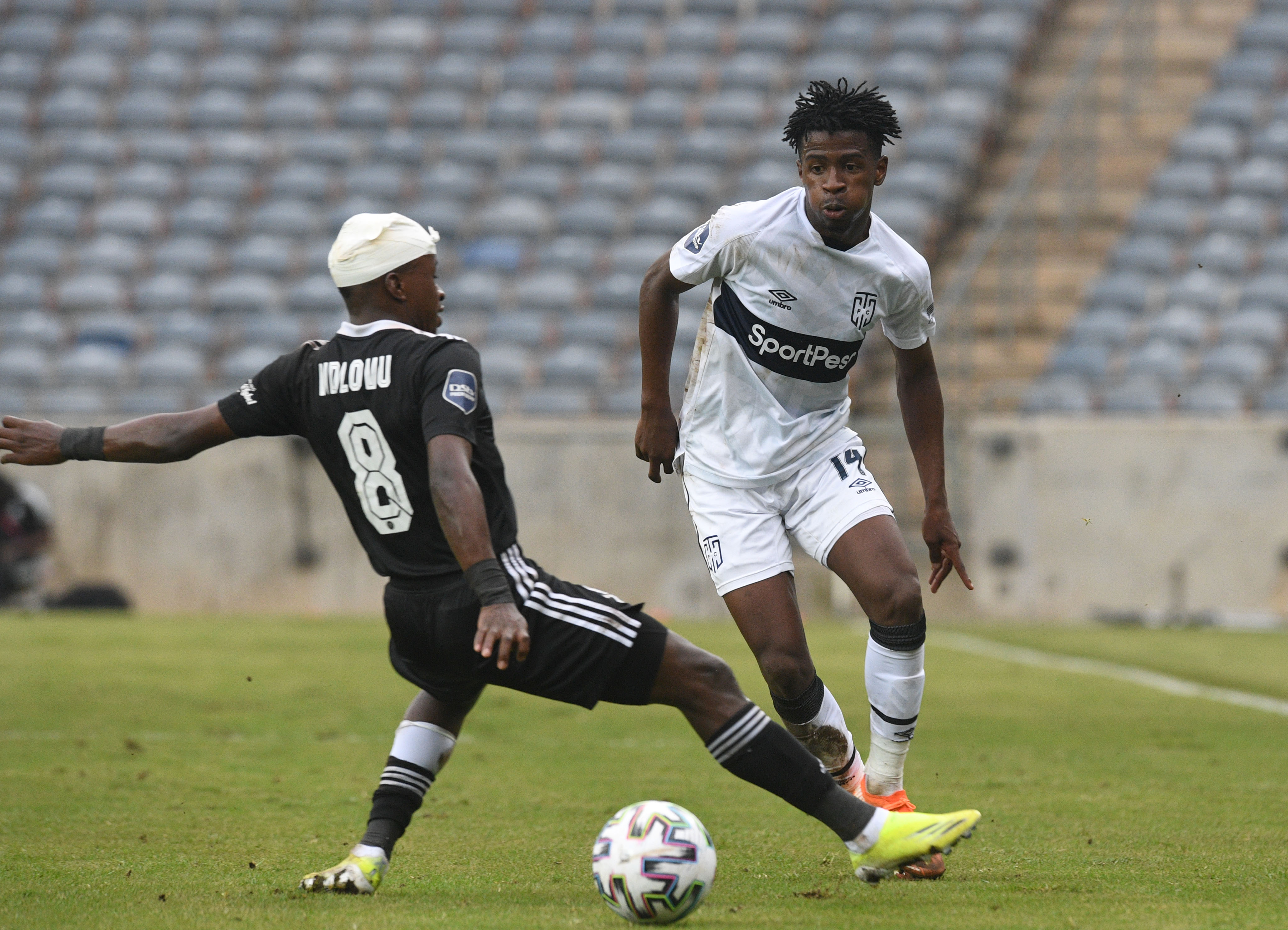 Terrence Mashego challenged by Siphesihle Ndlovu