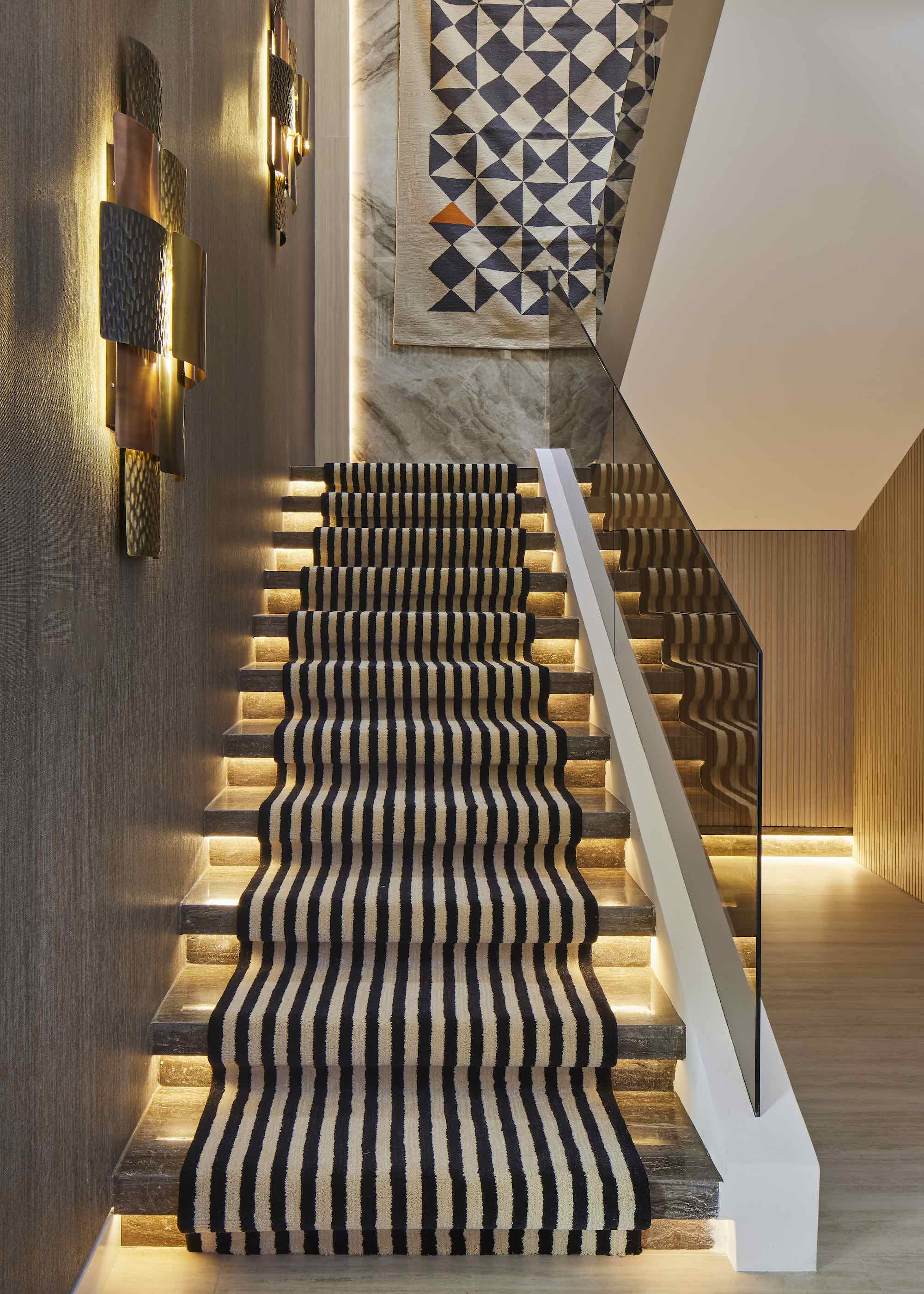 staircase with illuminated steps and striped runner place on the staircase