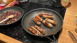Circulon SteelShield C-Series Frying Pan frying sausages